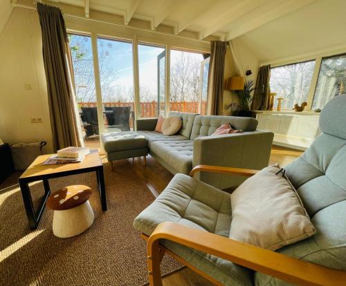 a living room with a couch and a table at La Cachette De Durbuy - Chalet 203 in Durbuy