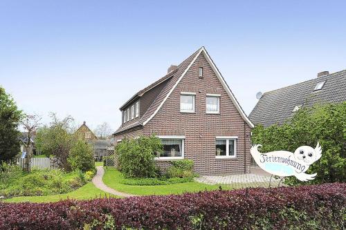 a house with a cat sign in front of it at Ferienhaus Ortgies in Carolinensiel