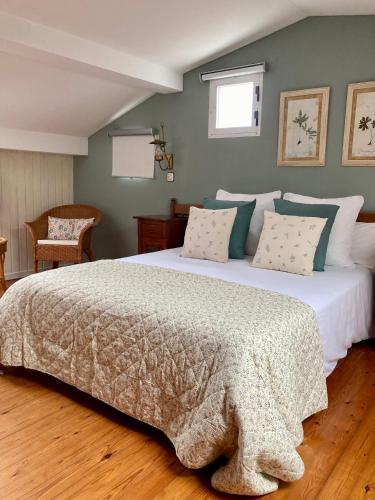 a bedroom with a large bed with a comforter at Posada Mellante in Pechón