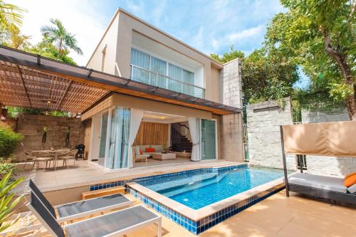 a swimming pool in the backyard of a house at Peach Blossom Resort & Pool Villa - SHA Plus in Kata Beach