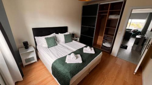 a bedroom with a bed with two towels on it at Apartment Beta - 2 Bedrooms, Private Rooftop Patio with Hot Tub, BBQ and View in Ferragudo