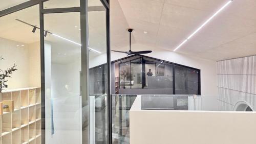 a room with a ceiling fan and a glass wall at FORESTE Haus 포레스테하우스 in Seoul