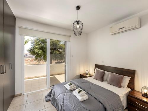 a bedroom with a large bed with towels on it at Mythical Sands CB04 in Paralimni