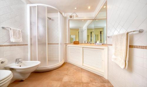 a bathroom with a shower and a sink and a toilet at Appartamenti sul mare in Santa Marinella