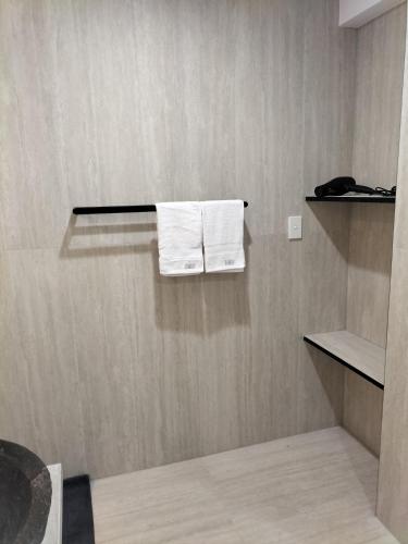 two towels hanging on a shelf in a bathroom at Maisie Haven in Brisbane