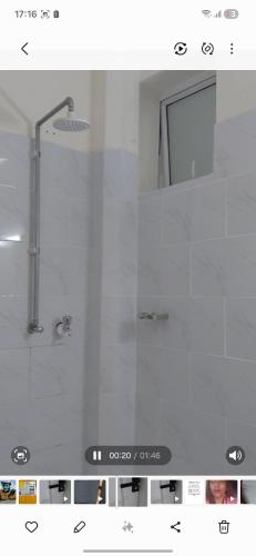 a bathroom with a shower and a mirror at Lins Haven in Kilifi