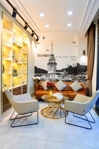 a living room with a couch and chairs at İSTPORT GARDEN HOTELS in Arnavutköy