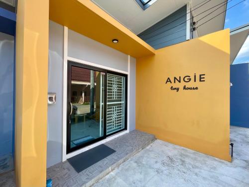 an angle new house signage on the side of a building at Angie Tiny House near Krabi Airport with Free Airport Shuttle