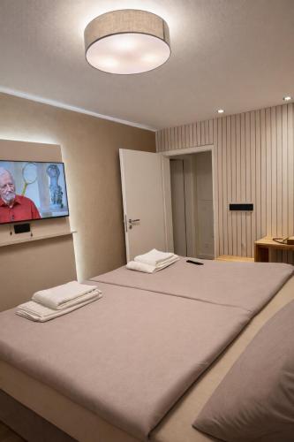 a bedroom with a large bed with two towels on it at LMB stays in Recklinghausen