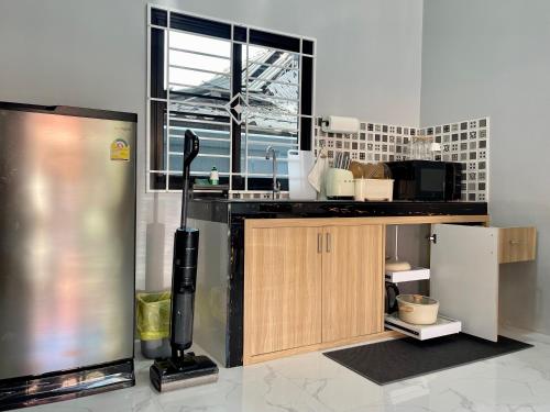 a kitchen with a counter and a refrigerator in it at Angie Tiny House near Krabi Airport with Free Airport Shuttle