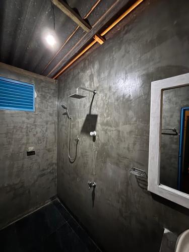 a bathroom with a shower and a sink at Hostel by Sri villa polwatta in Weligama