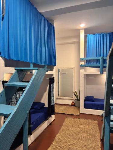 a bunk bed room with blue bunk beds at Hostel by Sri villa polwatta in Weligama