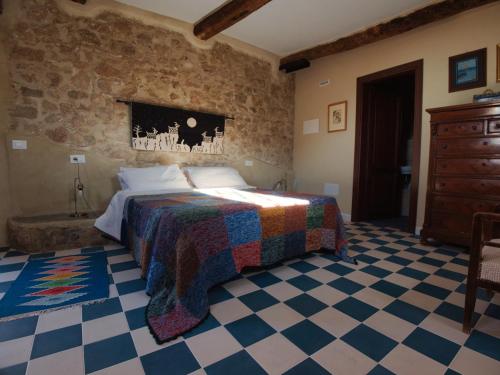 a bedroom with a bed with a checkered floor at B&B Manca1Fiorino in Spoleto
