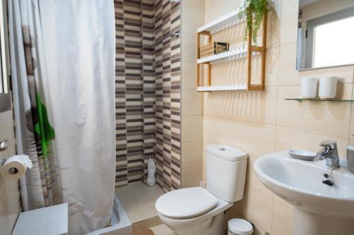 a bathroom with a toilet and a sink at Casa Alicia Altea By DelucaCo in Altea