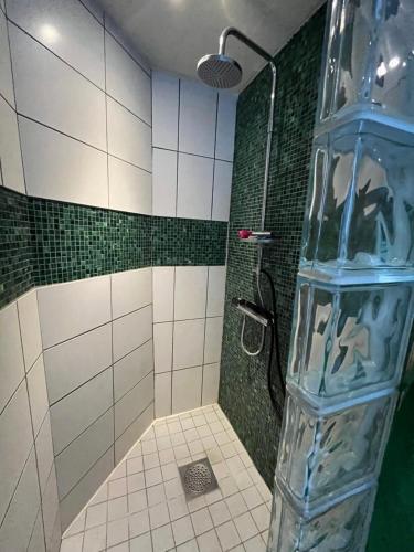 a bathroom with a shower with a clear plastic bottle at Kråksjöviken in Västervik