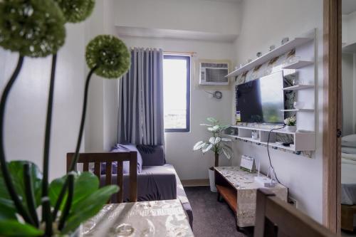 a living room with a couch and a tv at R and K staycation in Manila
