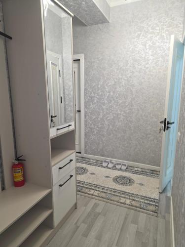 a bathroom with a shower with a large mirror at Guest house 2 in Fergana