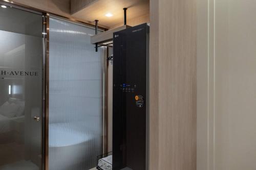 a shower with a glass door in a bathroom at H-Avenue Hotel Yeongildae in Pohang