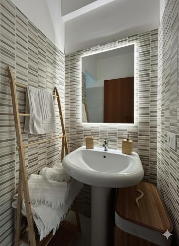 a bathroom with a sink and a mirror at A casa del nonno Jack in Letojanni