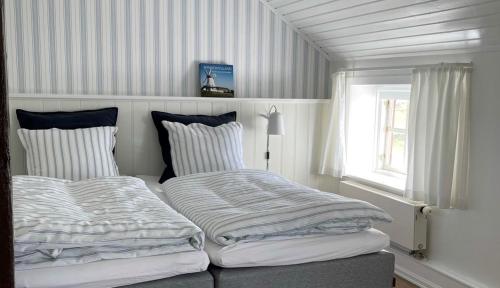 two beds sitting next to each other in a bedroom at Als Kloster in Sønderborg