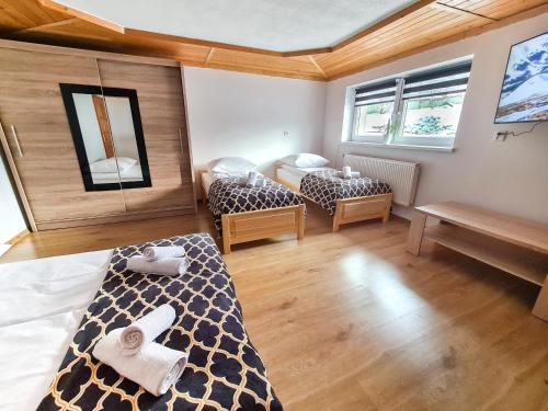 a bedroom with two beds in a room at Apartament Za Potokiem in Groń