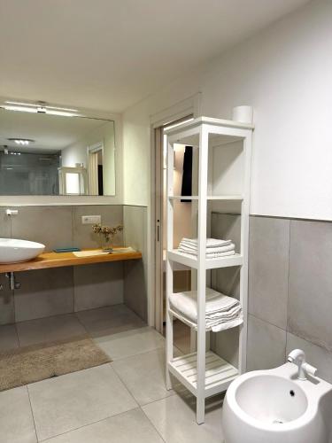 a bathroom with a sink and a toilet and a mirror at Villa Delia in Cernobbio