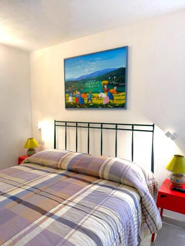 a bedroom with a bed and a painting on the wall at Villa Delia in Cernobbio