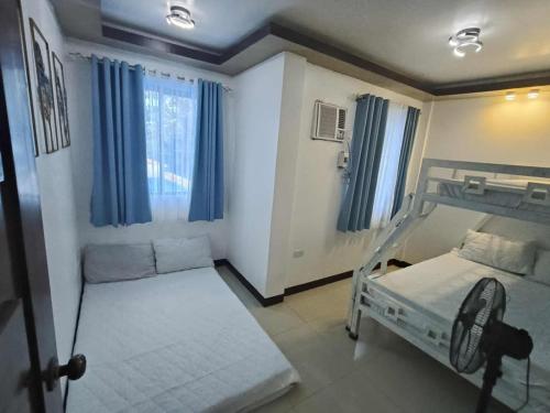 a room with two bunk beds and a window at Private Resort in Batangas in Lian