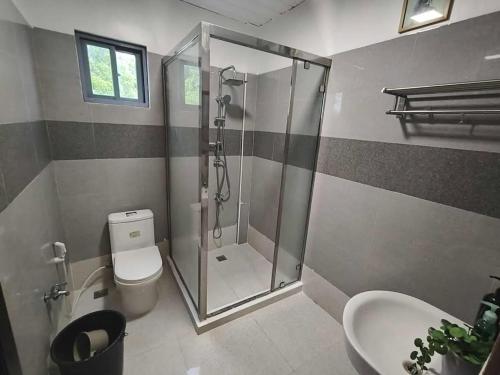 a bathroom with a shower and a toilet and a sink at Private Resort in Batangas in Lian