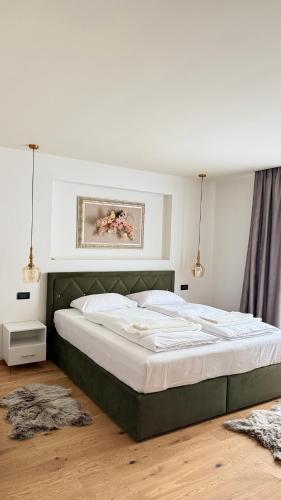 a bedroom with a large bed in a room at Pensiunea SOLEA in Ucea de Jos
