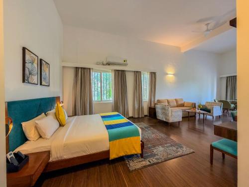 a bedroom with a bed and a living room at Spree Resort At Century Wintersun in Dod Ballāpur