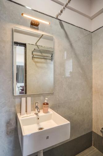 a bathroom with a white sink and a mirror at Hotel Zenora in Méribel Village