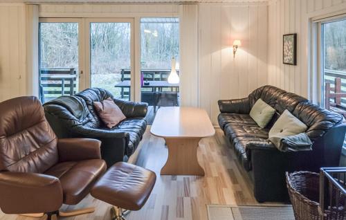 a living room with leather furniture and a table at Beautiful Home In Toftlund With Wifi in Toftlund