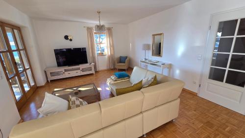 a living room with a couch and a tv at Ferienwohnung Dirscherl in Tiefenbach