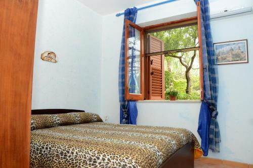 a room with a bed and a window at Holiday Homes in Campofelice di Roccella