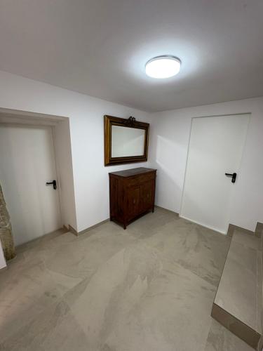 an empty room with a mirror and a dresser at Casa Brillantes in Ayerbe