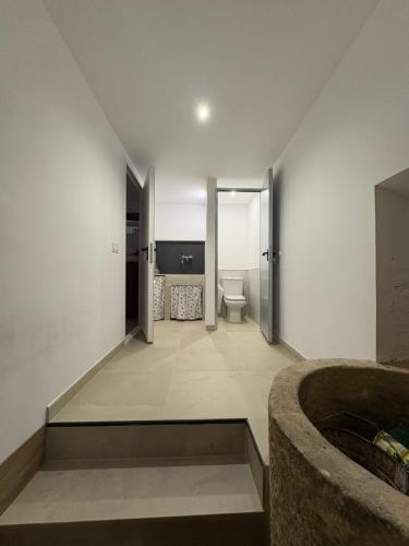 a bathroom with a sink and a toilet in a room at Casa Brillantes in Ayerbe