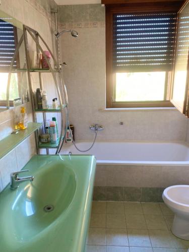 a bathroom with a tub and a sink and a toilet at Granaretto 27 in Palidoro