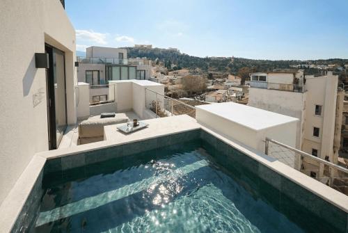 a swimming pool on the roof of a building at Bellén Athens Ηotel in Athens