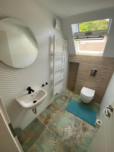 a bathroom with a sink and a toilet at Relaxen am Waldesrand Fewo 2 in Ahrbrück