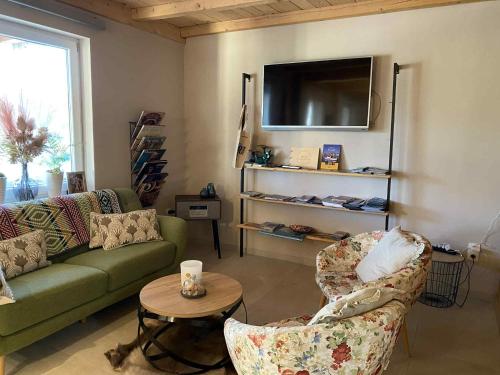 a living room with a couch and chairs and a tv at HOSTEL B&B Mama Mia - Budgetverblijf in Zaton Obrovački