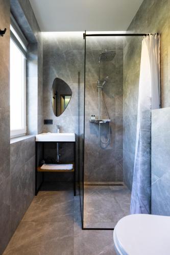 a bathroom with a shower and a sink at AINO Hotel in Pilipets
