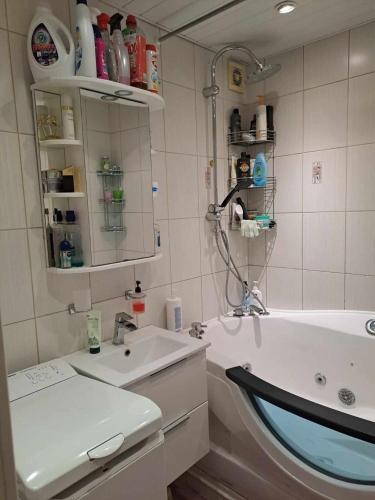 a bathroom with a sink and a tub and a mirror at A 3-bedroom apartment on the second floor in Tallinn