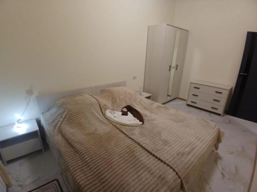 a bedroom with a bed with a hat on it at Eghipatrush Guesthouse in Aparan