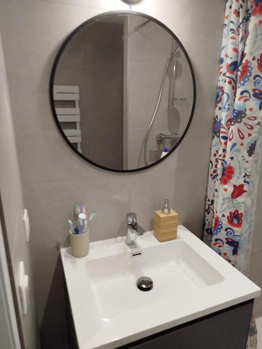 a bathroom with a white sink and a mirror at le victoire in Fréjus