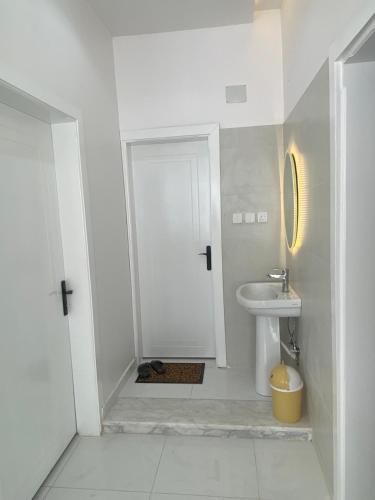 a white bathroom with a sink and a toilet at شاليه غيوم الفندقية in Taif