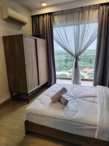 a bedroom with a large bed with a large window at Timurbay Seafront By Moonlight in Kuantan