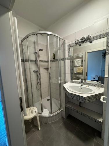 a bathroom with a shower and a sink at Hotel Zur schönen Aussicht in Grömitz