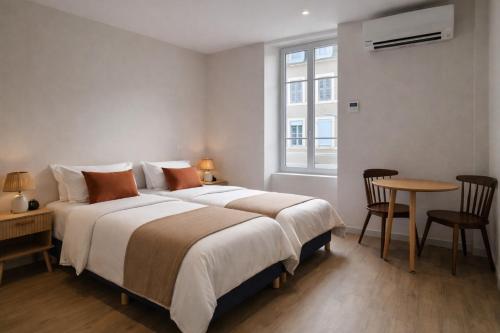 a bedroom with a bed and a table and a window at Hôtel des Thermes in Bourbon-Lancy