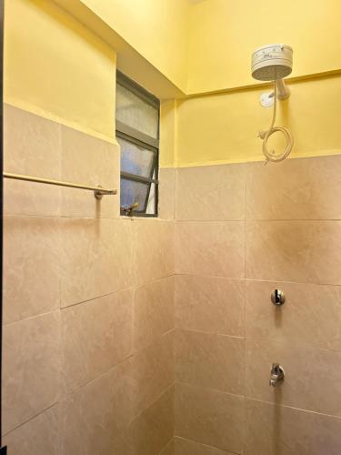a bathroom with a shower with a window at Gated executive 1 bed in gated near Top Malls, Kisumu in Kisumu